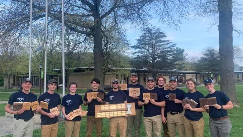 Members of the 2023 伐木工人团队 hold plaques after winning first place at the 2023 Mid-Atlantic Woodsmen's Meet